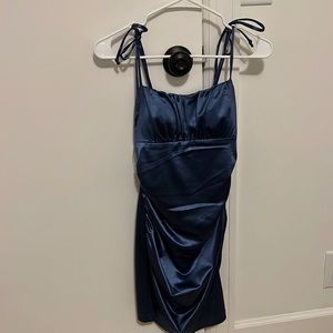 Blue satin dress. Has a few minor stains that will come out with dry cleaning.